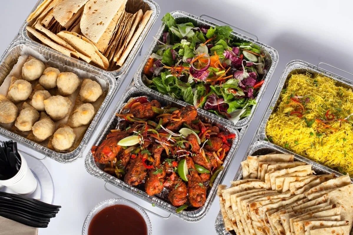 A Sonny's Indian Kitchen catering spread: curries, biryani and fresh naan in chafing dishes